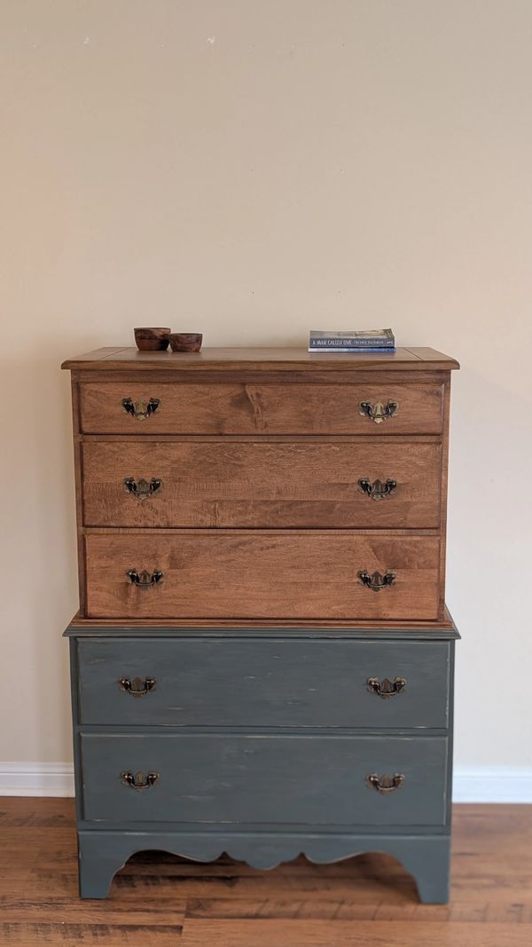 A two-tone wooden dresser with three small drawers on top and two larger painted drawers below.