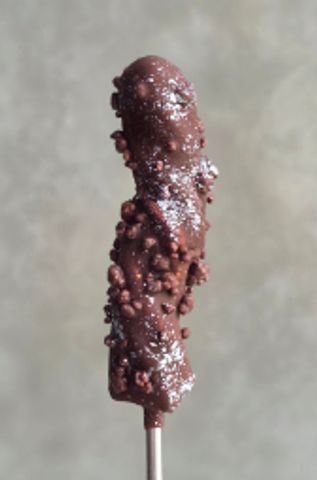 Chocolate-covered banana with crunchy bits on a stick.