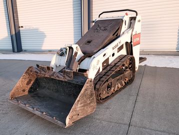 Ultra compact Skid loader, parked in front of fremont Nebraska warehouse.
