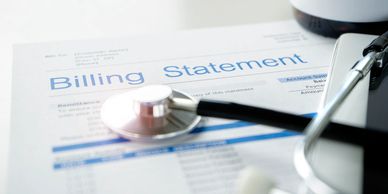 A piece of paper with the heading of "Billing Statement" next to a stethoscope.