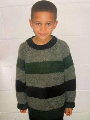 Chandler Bussey wears a two-tone green wool sweater to elementary school.