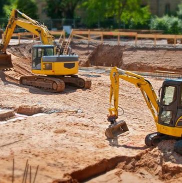 Excavator and bulldozer preparing a build site in Columbus Ohio and grading the terrain.