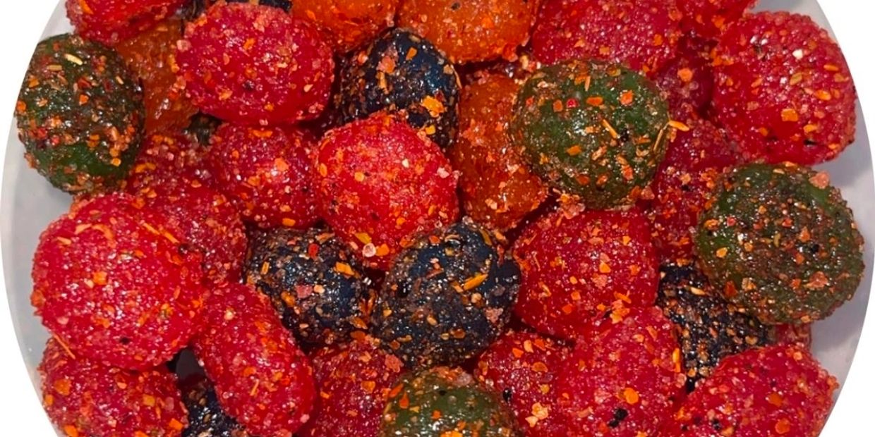 Colorful spicy-coated berries or candies in close-up.