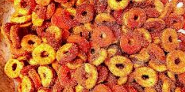 Close-up of colorful cereal rings in red, orange, and yellow hues.