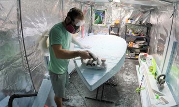 Shaper Trey Kerby making a custom river surfing paddleboard