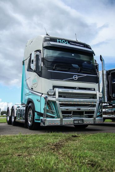 A modern Volvo truck with HGL Transport branding parked outdoors.