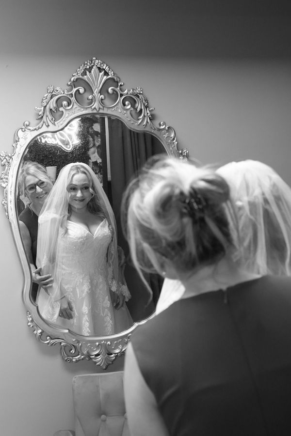 Bride and mom take a last look in the mirror just before the wedding ceremony at our chapel.