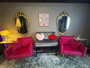 Hot pink chairs, velvet accents and gold mirrors in the bridal suite.