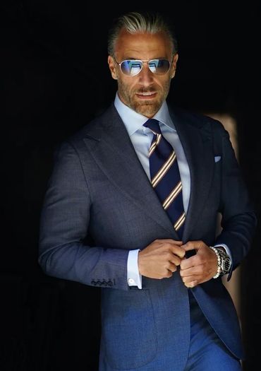 Men's grey suit blue striped tie light blue dress shirt blue hankie