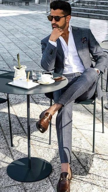 Men's grey suit with white dress shirt with grey hankie and brown loafers with black sunglasses