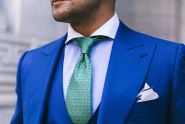 bright blue custom made suit with custom made white dress shirt emerald green tie with white hankie