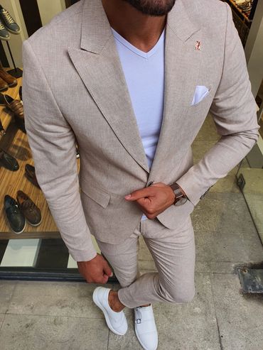 Men's tan suit with white hankie and white shoes