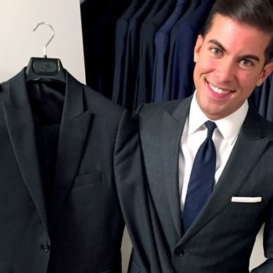 Men's custom tailored charcoal grey suit. Custom made white dress shirt with black tie white hankie