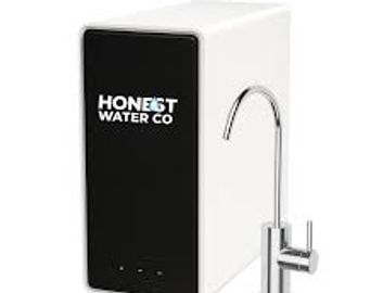 Modern water purifier with sleek design and faucet.