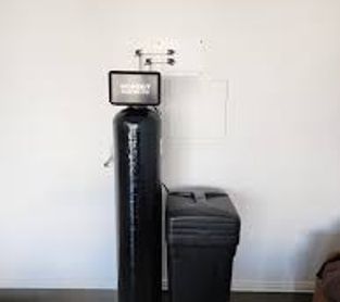 Water softener system with control unit and salt tank.