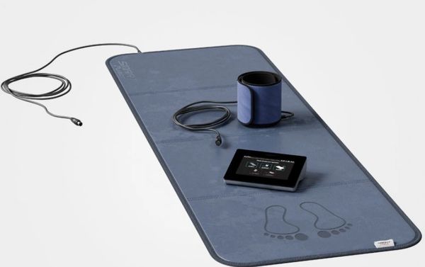 A blue medical device mat with a blood pressure cuff and digital monitor.