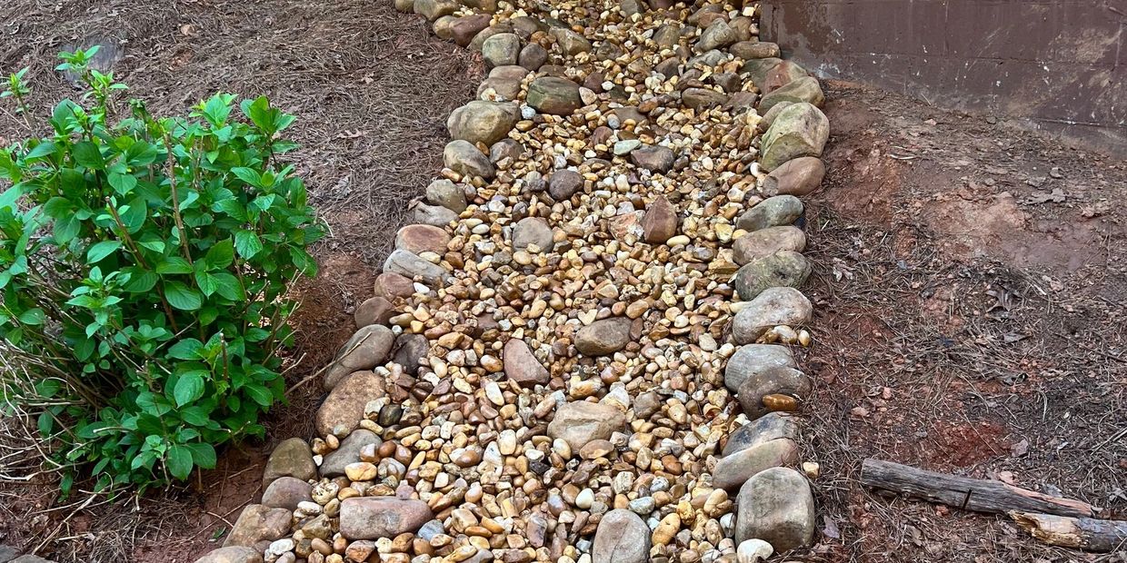 dry creek bed with river rock for drainage