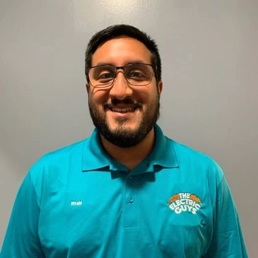 Project Manager, Ryan, wearing a blue Electric Guys uniform and smiling.