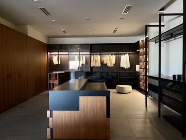 Bedroom remodel with tile floor, and dark -colored closer space and black and wood countertops