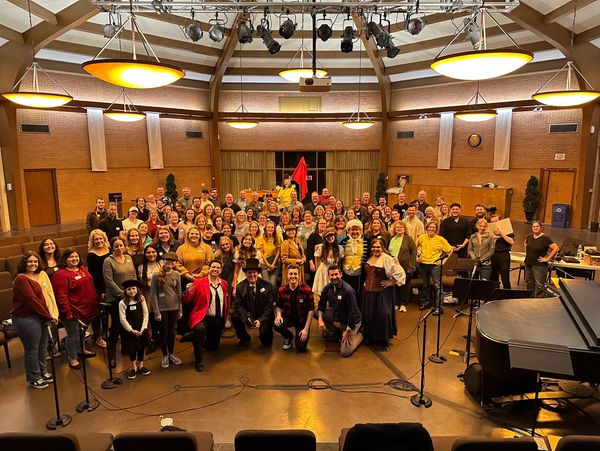 Smiling participants after a successful read-through of an anonymous musical.