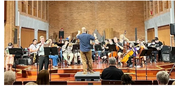 Orchestra and chorus with a solo singer performing