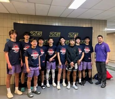 Youth basketball team posing with their coach after a game.
