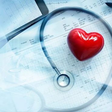 Red heart with stethoscope on medical documents symbolizing heart health.