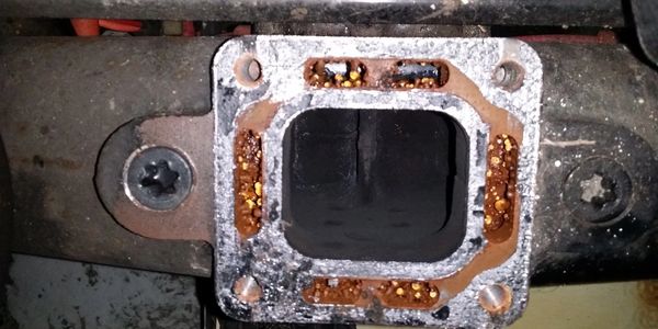 Close-up of a corroded metal engine component.