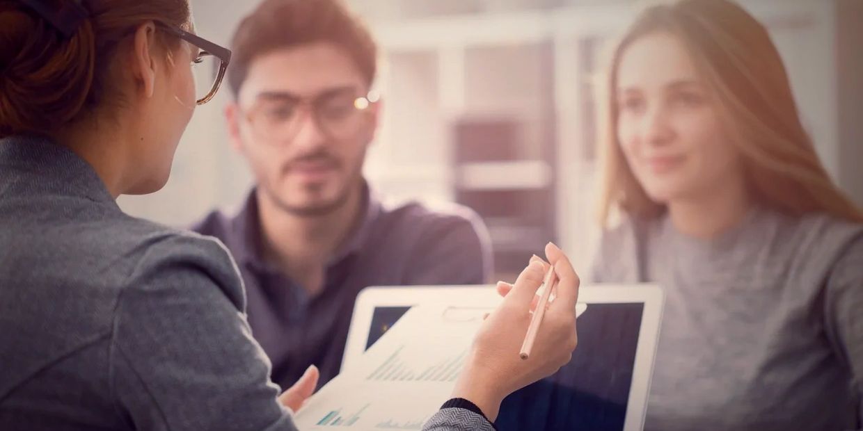 Accountant discussing taxes financial planning with her clients.