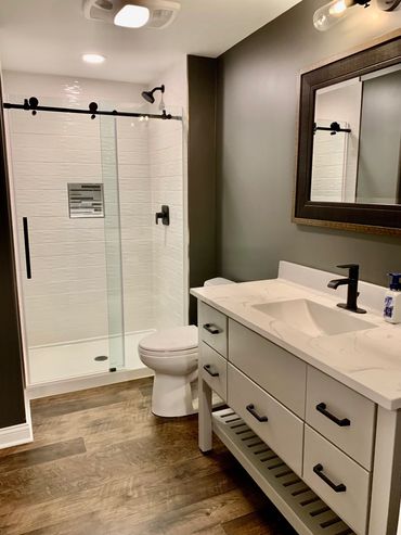 Basement bathroom build and remodel in Frankfort with custom shower and furniture style vanity