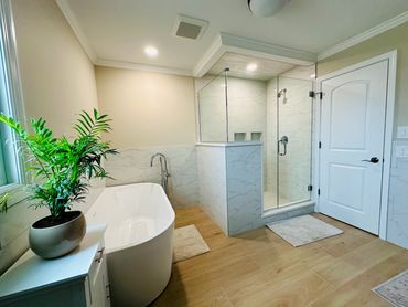 Master bathroom remodel with tile floor, shower with bench, and soaking tub in Frankfort