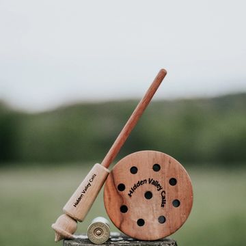 Wooden fishing reel and rod set with 'Hidden Valley Calls' engraving.