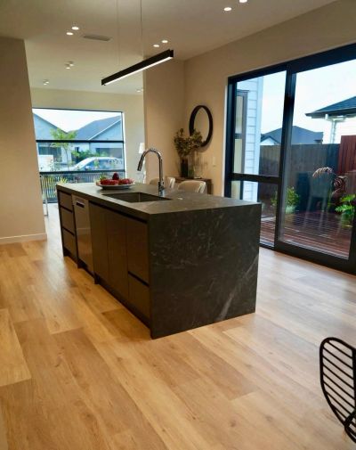 Modern kitchen renovation in Hawke's Bay featuring custom cabinetry, premium benchtops, timber floor