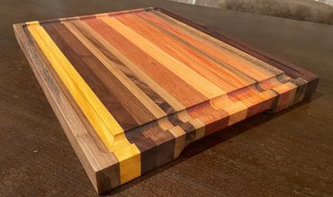 Rebel 75; 15 1/4" x 12 1/4" x 1 1/4" edge grain exotic woods cutting/serving board