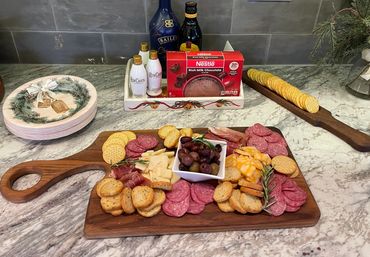 Solid walnut New Age Charcuterie Board with curved handle.