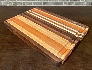 Rebel 56 Approximately 17 1/2" x 12" x 1 5/8" EDGE grain exotic hardwoods cutting/serving board