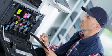 A technician checking printer functions