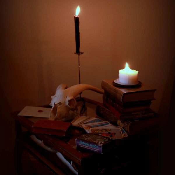 Candle Altar with Goat Skull and Tarot Cards on Books
Photographer Jael Montellano