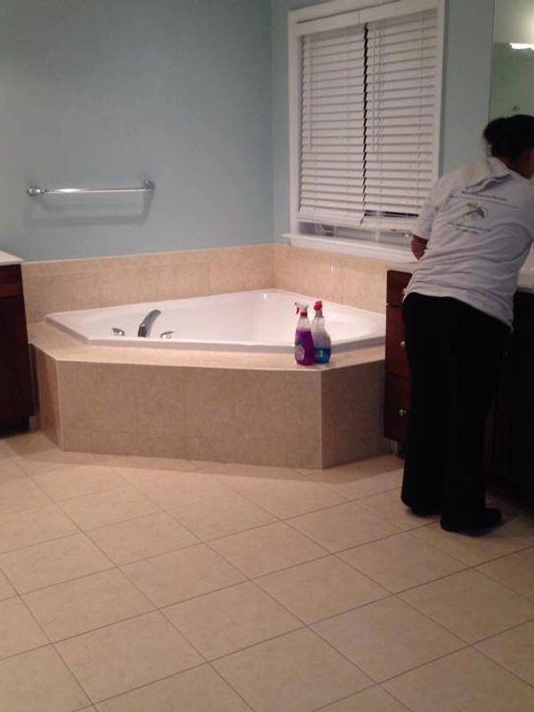A Woman Cleaning a Bathroom Room