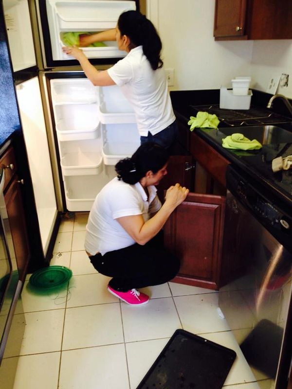 Two Woman Cleaning a Kitchen Room