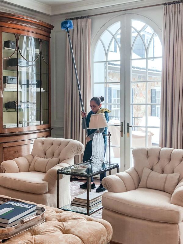 A Woman Cleaning a Living Room