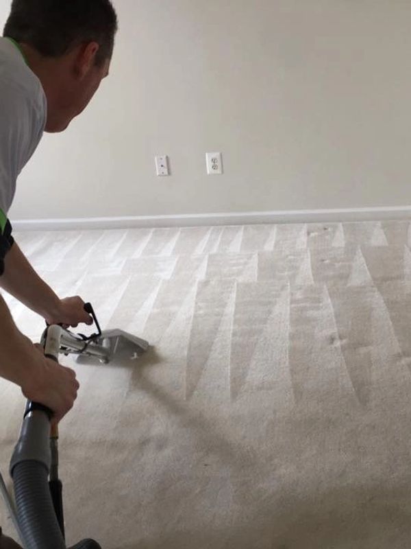A Man Cleaning a Carpet