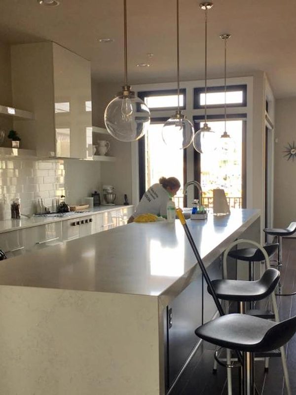 A Woman Cleaning a Kitchen Room
