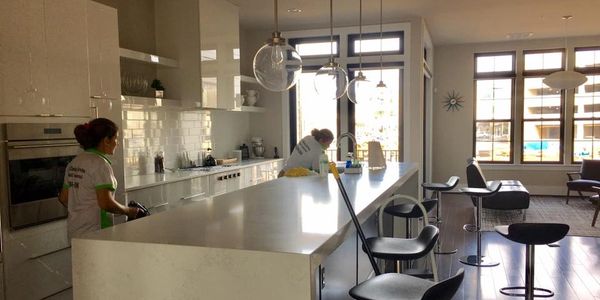 Two Woman Cleaning a Kitchen Room