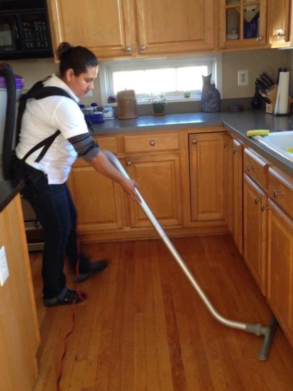 A Woman Cleaning a Kitchen Room