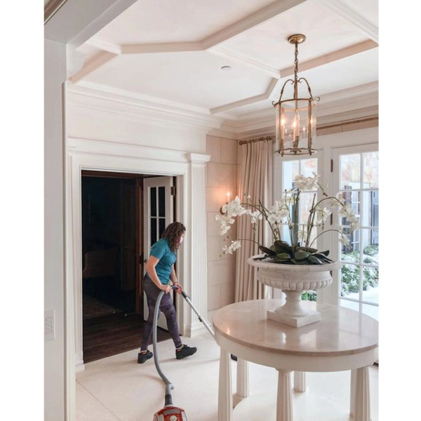 A Woman Cleaning a Living Room