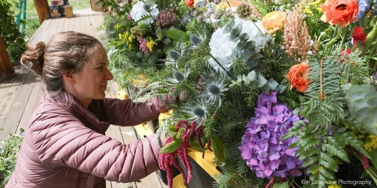 A florist arranging colorful booms.