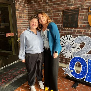 Two women standing together smiling