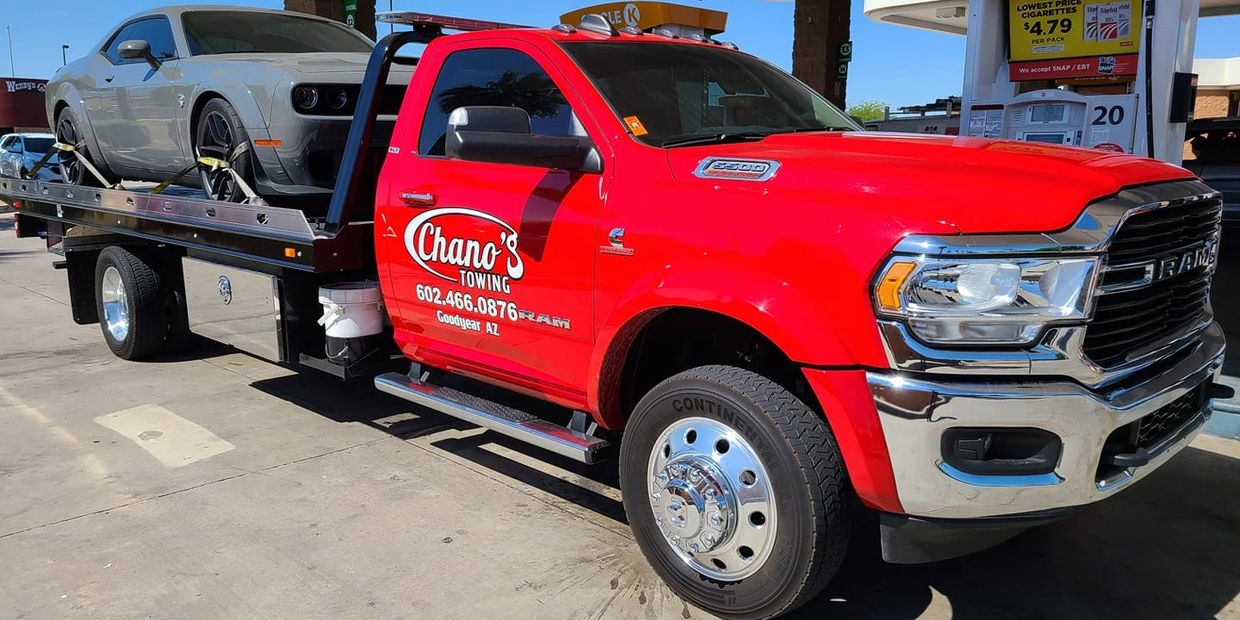 Chano's Towing, the best rated tow truck company in Goodyear flat bed towing a Dodge Challenger,