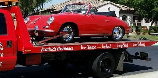 Chano's Towing taking a classic red auto from Goodyear to Buckeye on it's top rated flat bed wrecker